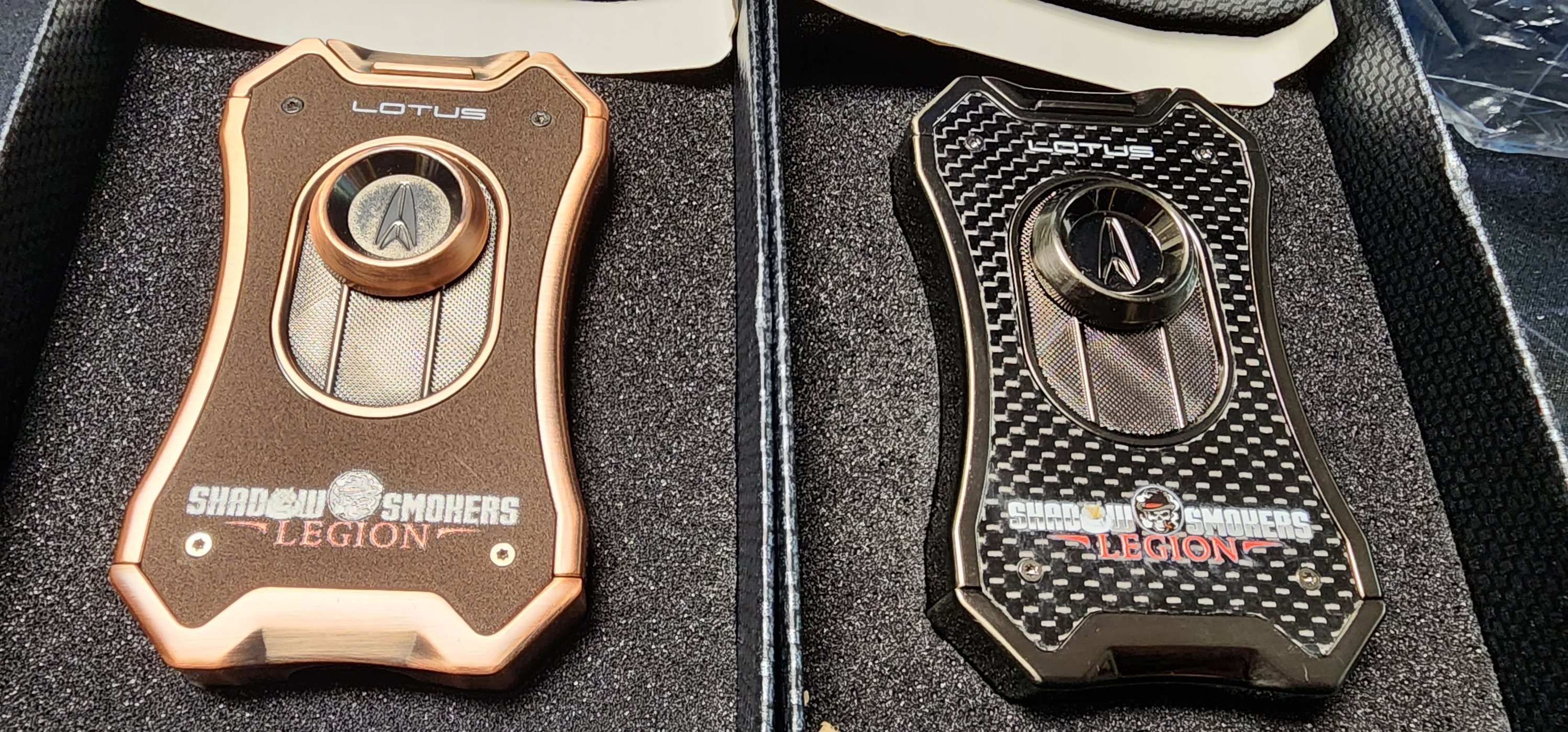 Copper leather and black carbon-fiber Lotus lighters branded for the Shadow Smokers Legion
