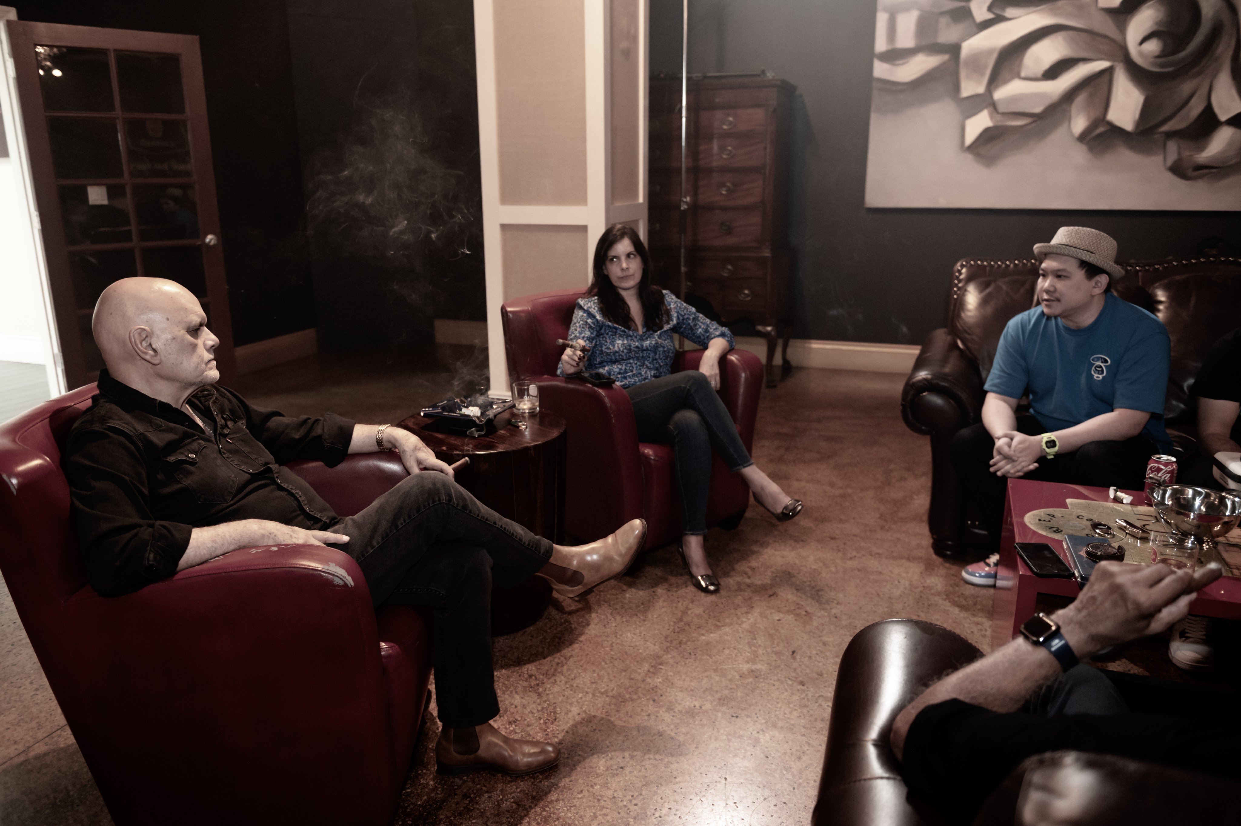 Shadow Smokers Legion members talking in leather chairs during a lounge session