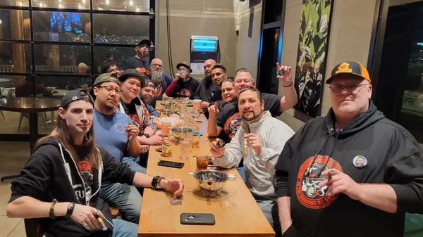 Legion members gathered around a long dinner table